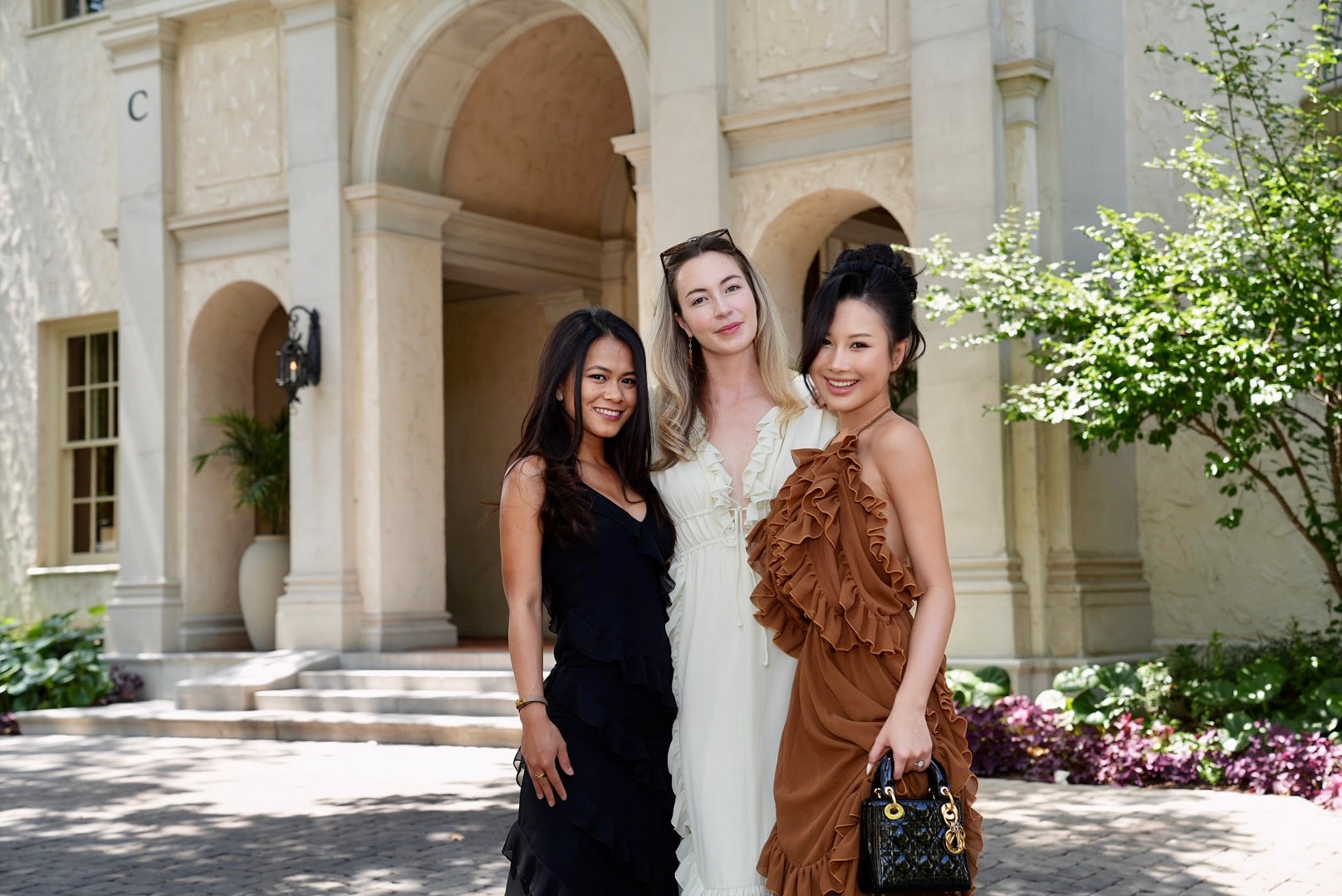Elegantly dressed guest in soft pastels at a garden gathering